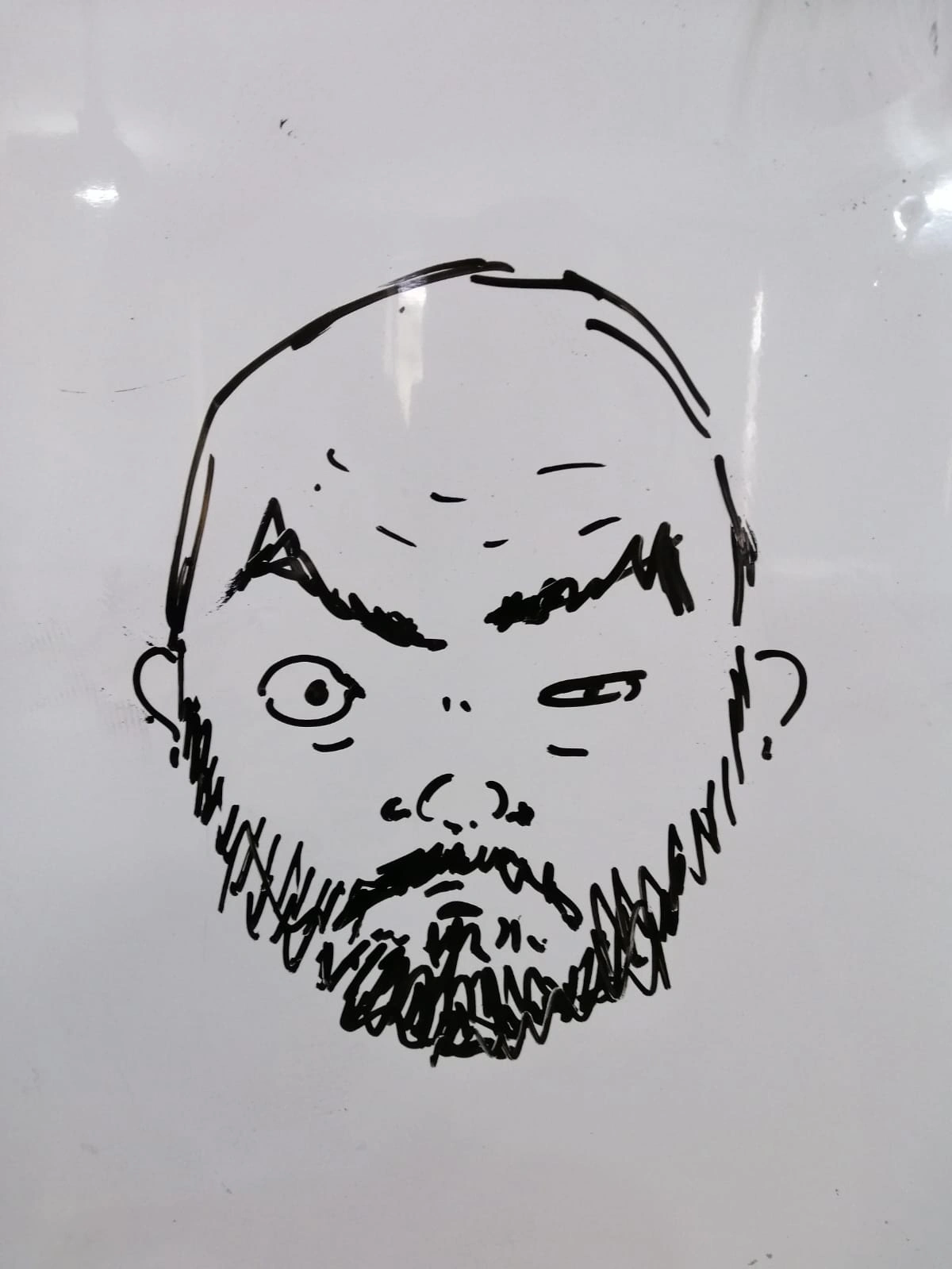 Drawing of a bearded man with a furrowed brow and one eye squinting, illustrating a humorous or skeptical expression, relevant to Moe Al Lakkis's creative approach in job ad marketing.